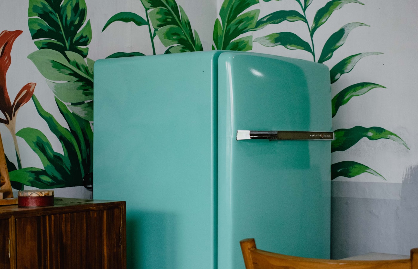 Technician checking refrigerator repair cost in Dallas TX kitchen